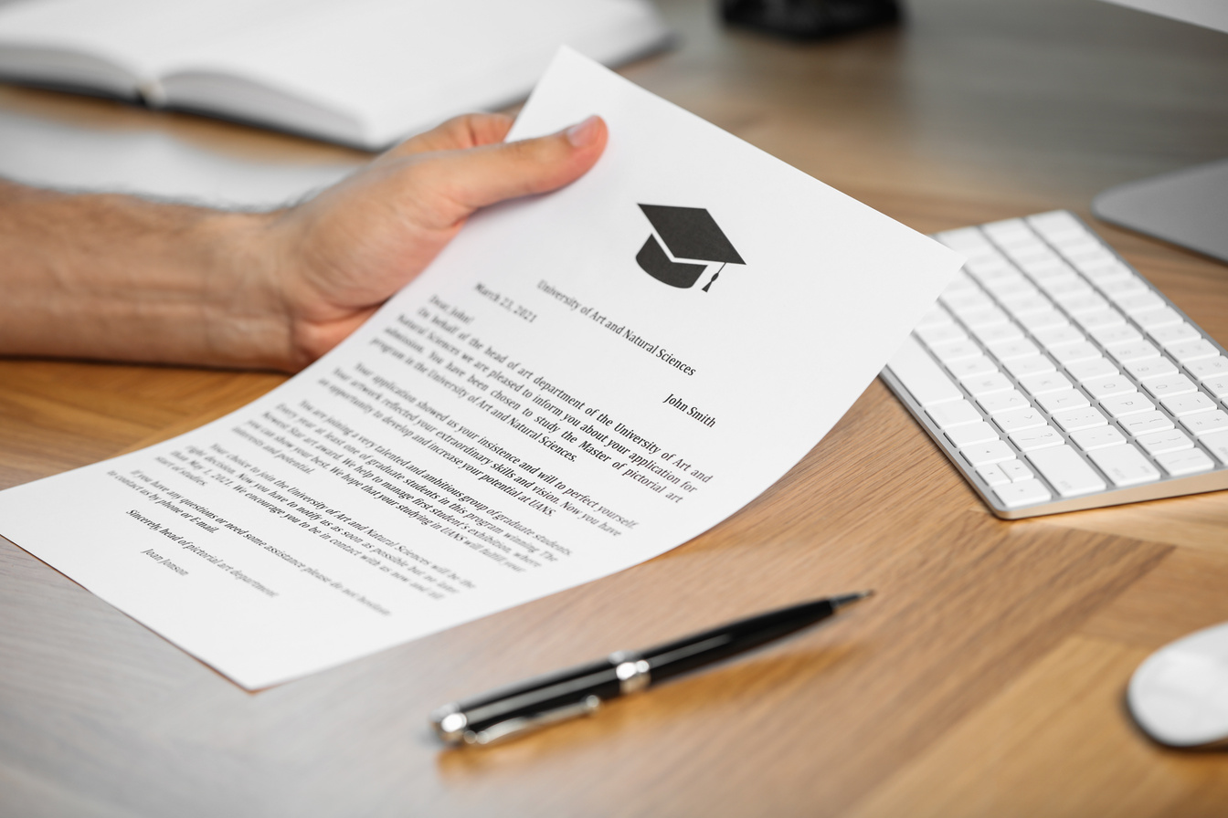 Student with Acceptance Letter from University at Wooden Table I